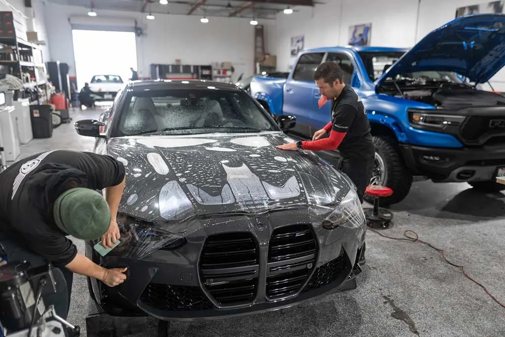 2024 BMW G80 M4 in Dravit Grey during hood Paint Protection Film installation